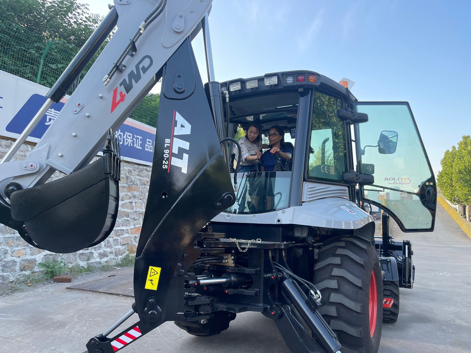 Backhoe loader operator guide showing controls and digging operation