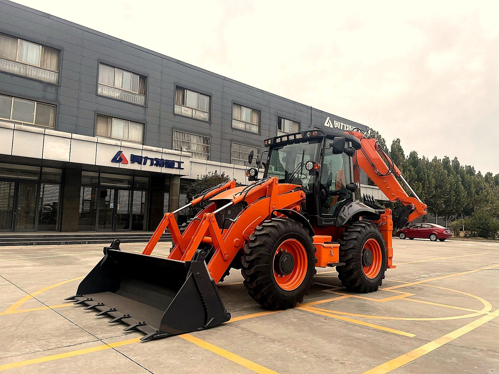 Backhoe loader vs wheel loader comparison on loading bay