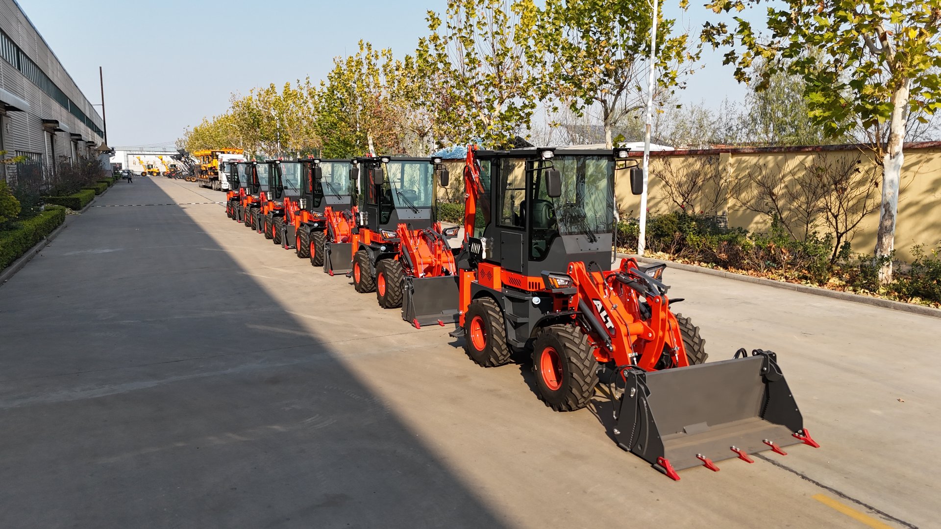 Line of backhoe loaders parked outside the AOLITE Heavy Industry factory