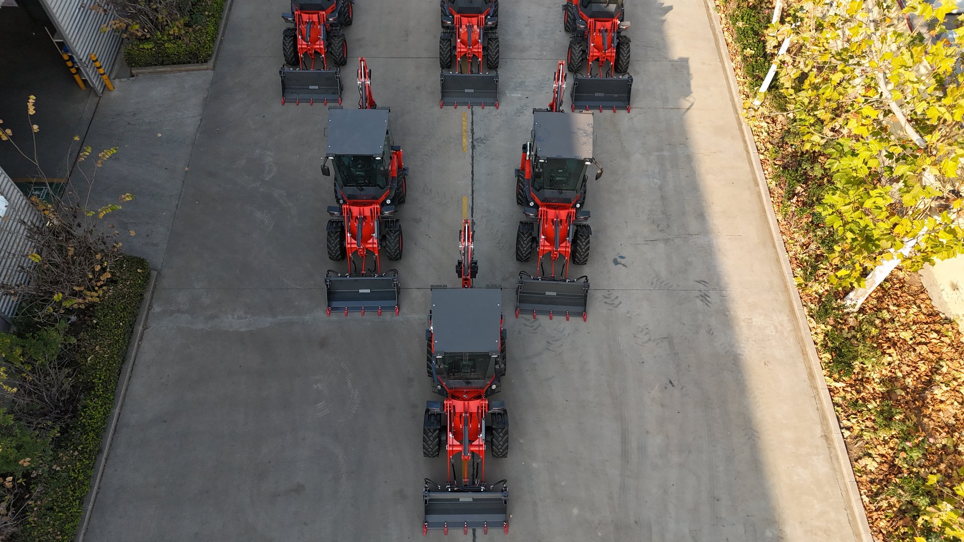 Aerial view of a fleet of backhoe loaders lined up at the AOLITE Heavy Industry factory
