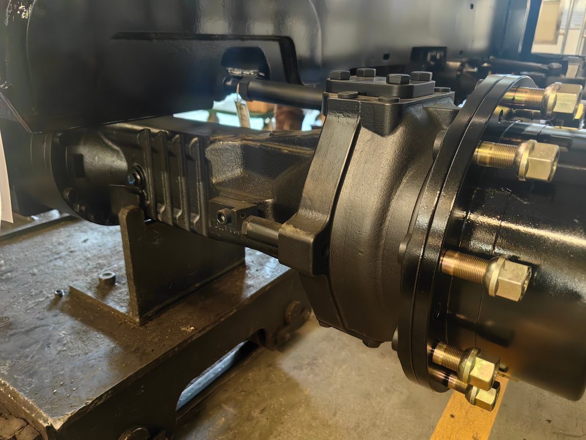 Wet drive axle brake housing on a heavy-duty backhoe loader