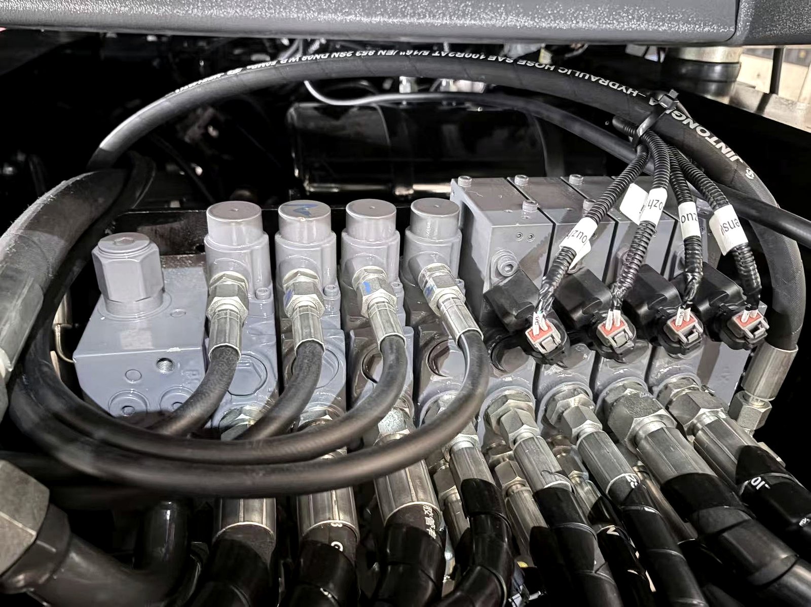 Close-up of backhoe loader components and hydraulic details