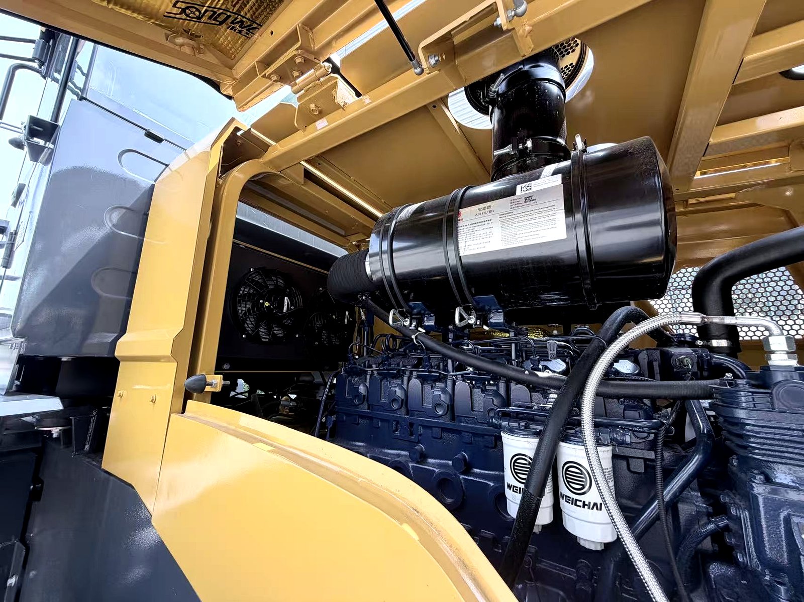 Backhoe loader cooling and hydraulic component detail inspection