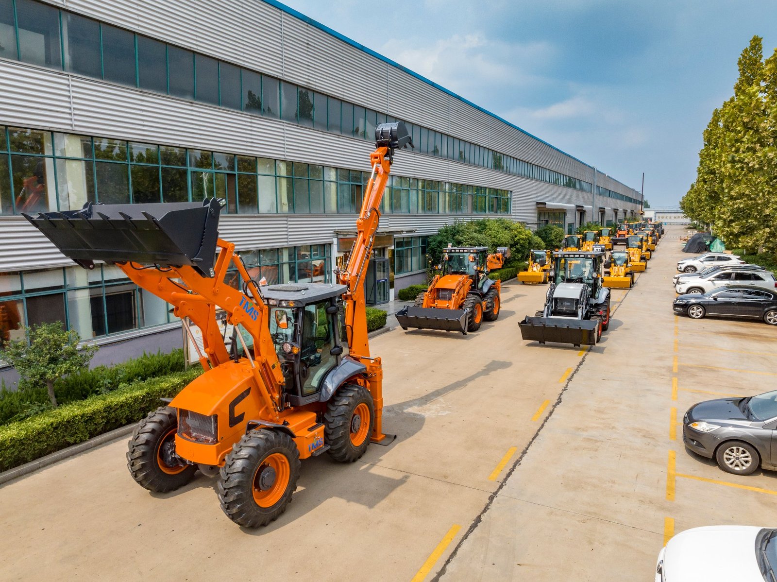 Aolite factory yard with backhoe loaders lined up ready for export