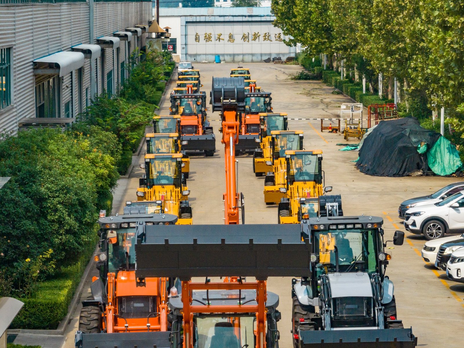 Backhoe loaders configured for hot-climate export markets
